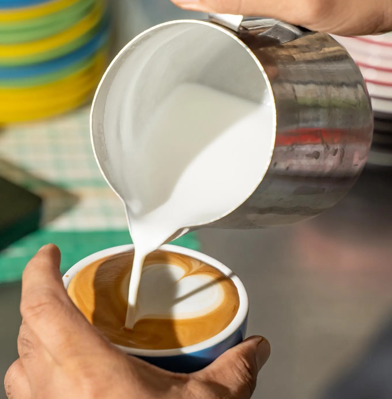 Artisan specialty coffee served with a serene Brisbane River backdrop at Bliss on Riverside